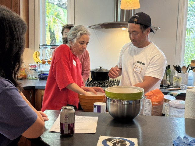 Neighbors cooking together in a home kitchen